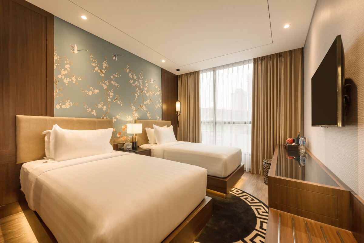 A modern hotel room with two twin beds