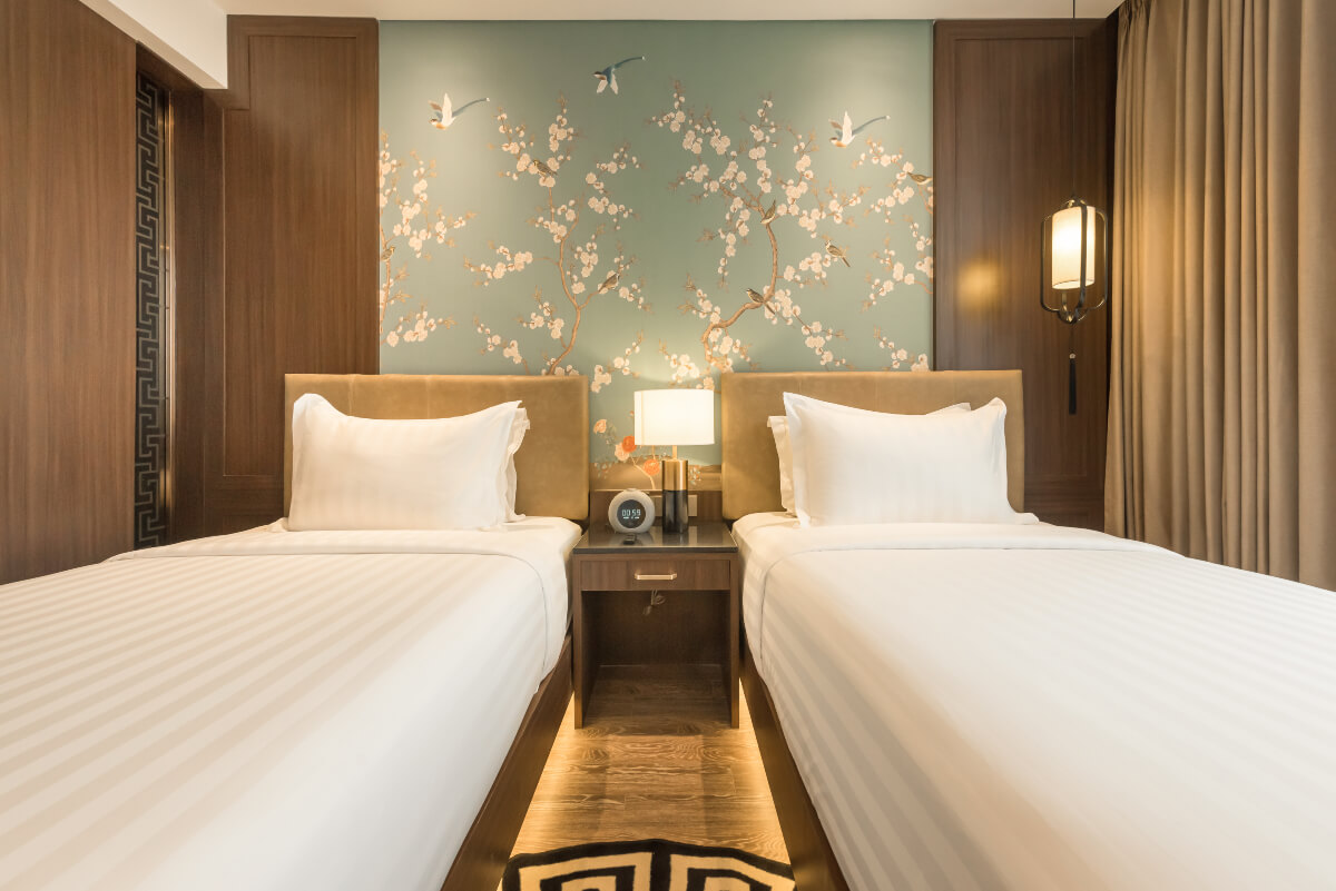 A modern hotel room with two twin beds