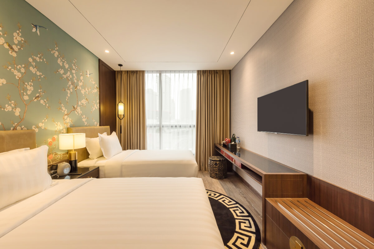 A modern hotel room with two twin beds