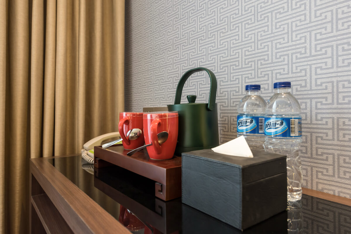 Bright hotel room with twin beds and a city view