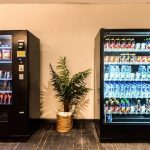 Modern black vending machine in a hotel lobby