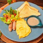 A Western breakfast plate with eggs, sausage, and bacon