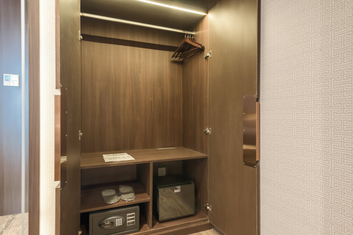 Wooden wardrobe in the Ashley Tang hotel room