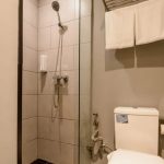 A modern YBTA bathroom with a backlit mirror