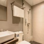 YBTA Bathroom with a backlit round mirror and vessel sink