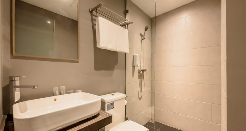 YBTA Bathroom with a backlit round mirror and vessel sink