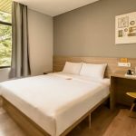 A modern YBTA Deluxe Double room with a large bed