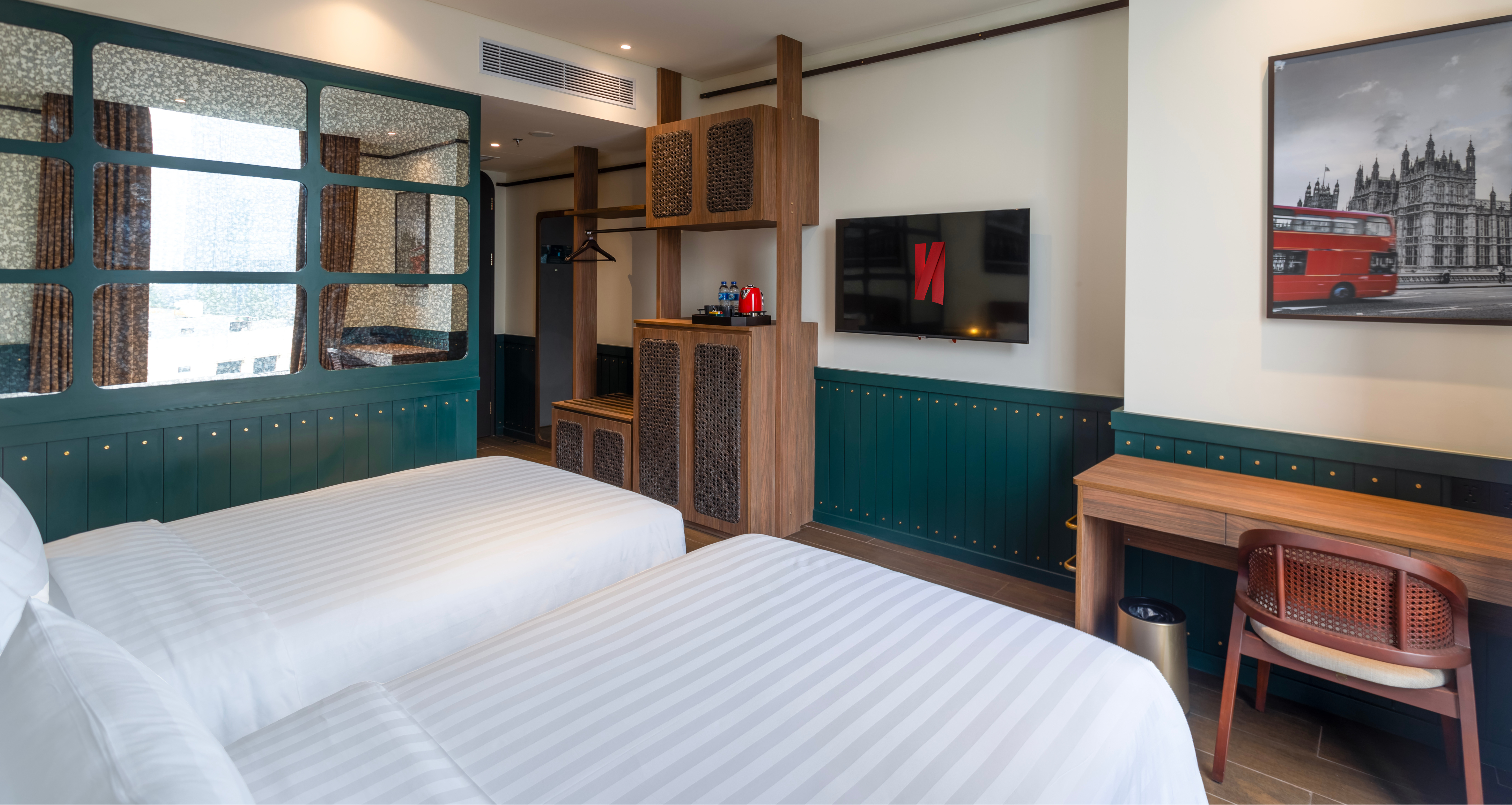 Ashley Hotel Group twin room with a city skyline view