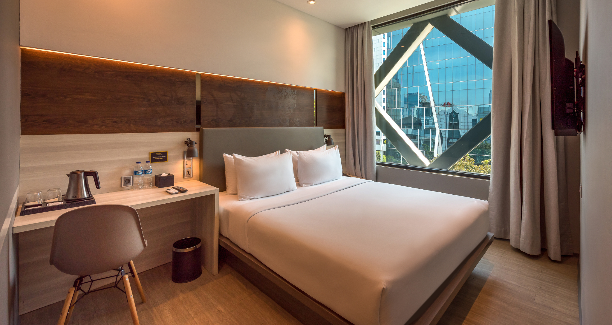 Ashley Hotel Group modern room with a large bed and city view