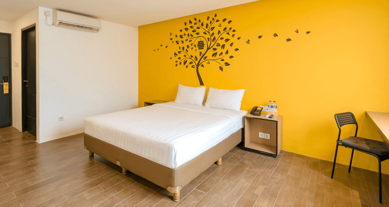 A well-lit Superior King hotel room with a large bed