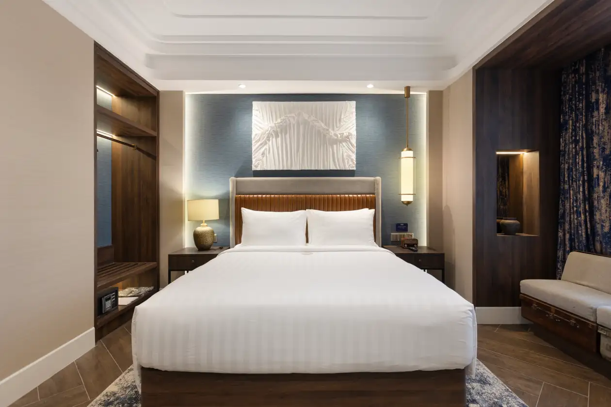 Newair Deluxe Queen hotel room with blue accent wall