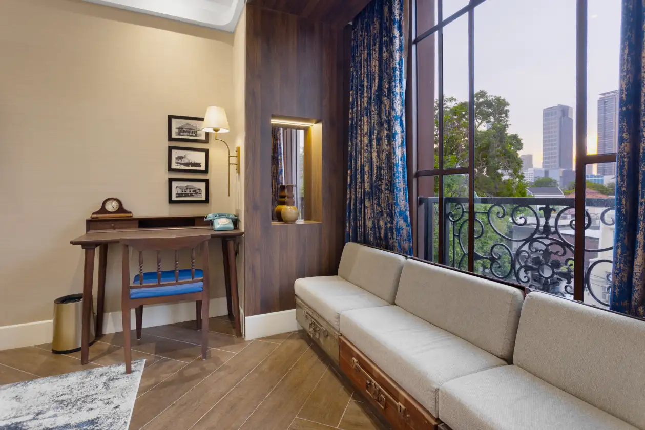 Executive Queen room interior with vintage desk and city view