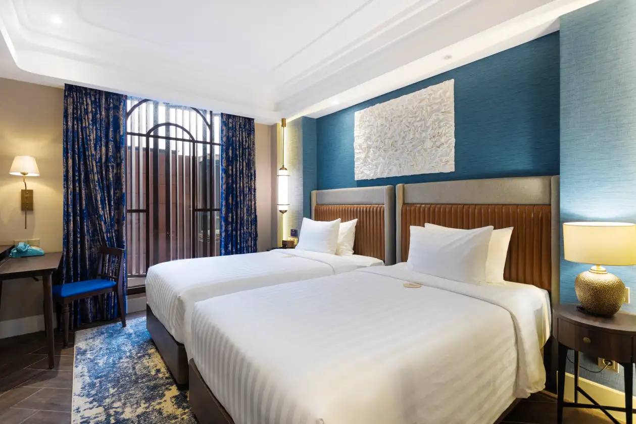 Superior twin room featuring blue decor and leather headboards