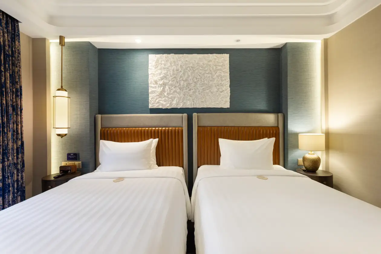 Newair Superior Twin room with teal wall and two beds